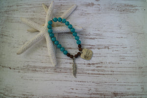 Turquoise and wood beaded bracelet with rustic silver 'dreaming of the sea' charm and boho feather charm