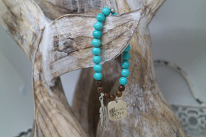 Turquoise and wood beaded bracelet with rustic silver 'dreaming of the sea' charm and boho feather charm