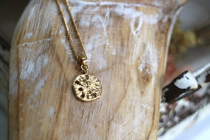 Gold sand dollar shell necklace