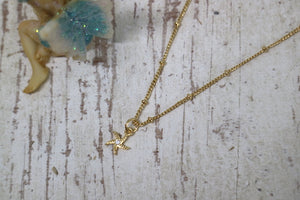 Children's gold starfish necklace with cubic zirconia