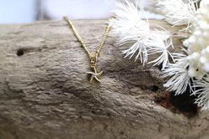 Children's gold starfish necklace with cubic zirconia