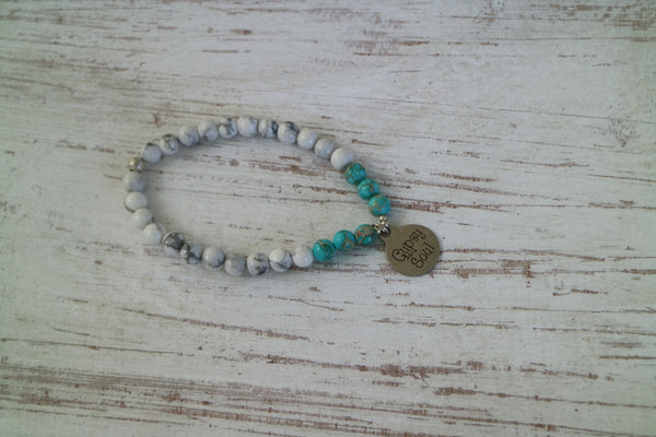 Load image into Gallery viewer, White howlite and blue sea sediment jasper gemstone beaded bracelet with silver &#39;gypsy soul&#39; charm
