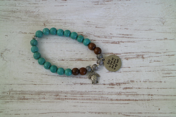 Load image into Gallery viewer, Turquoise and wood beaded bracelet with silver &#39;salt in the air and sand in my hair&#39; and turtle charm
