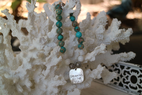 Load image into Gallery viewer, Blue Sea Sediment Jasper and white howlite gemstone beaded bracelet with rustic silver &#39;dreaming of the sea&#39; charm
