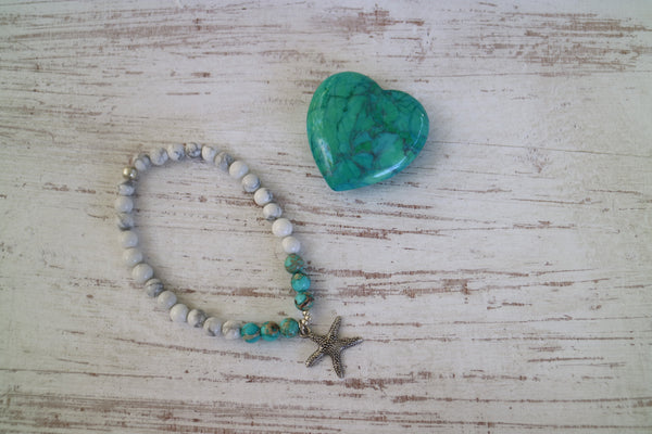 Load image into Gallery viewer, White howlite and blue sea sediment jasper gemstone beaded bracelet with silver starfish charm
