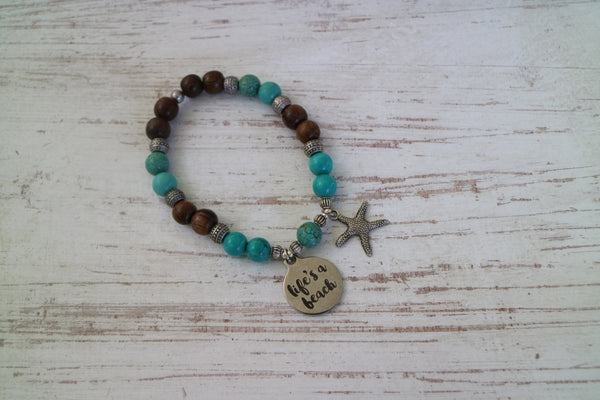 Load image into Gallery viewer, Turquoise gemstone and wood beaded bracelet with silver &#39;life&#39;s a beach&#39; and starfish charms
