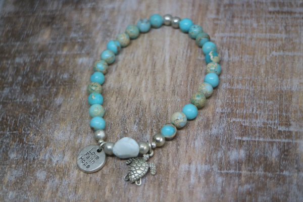 Load image into Gallery viewer, Blue Sea Sediment Jasper gemstone beads with Larimar nugget bead and silver &#39;love faith hope&#39; and turtle charms
