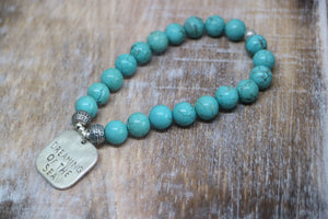 Blue Turquoise bead bracelet with a silver 'dreaming of the sea' rustic charm