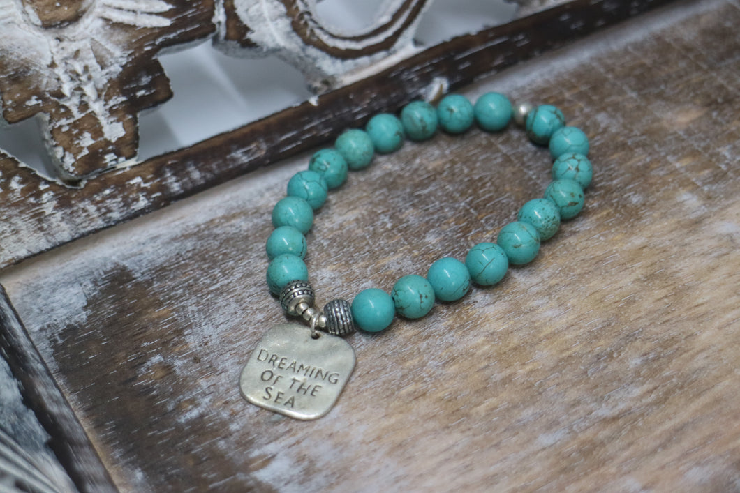 Blue Turquoise bead bracelet with a silver 'dreaming of the sea' rustic charm