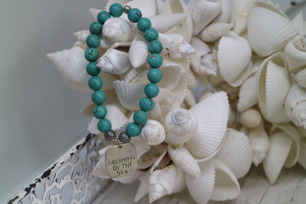 Load image into Gallery viewer, Blue Turquoise bead bracelet with a silver &#39;dreaming of the sea&#39; rustic charm
