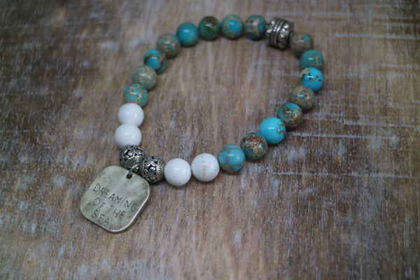 Load image into Gallery viewer, Blue Sea Sediment Jasper and white howlite gemstone beaded bracelet with rustic silver &#39;dreaming of the sea&#39; charm
