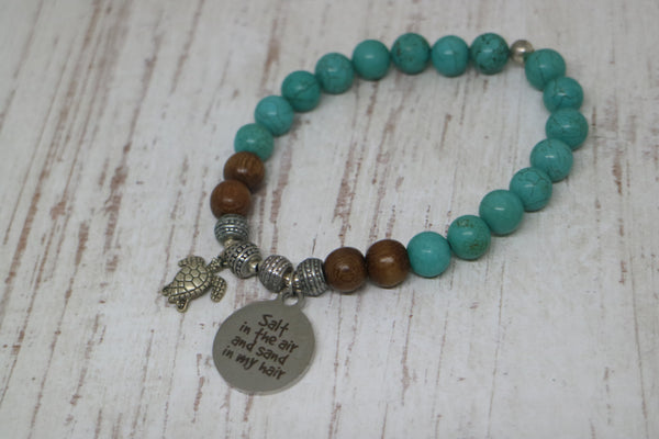 Load image into Gallery viewer, Turquoise and wood beaded bracelet with silver &#39;salt in the air and sand in my hair&#39; and turtle charm
