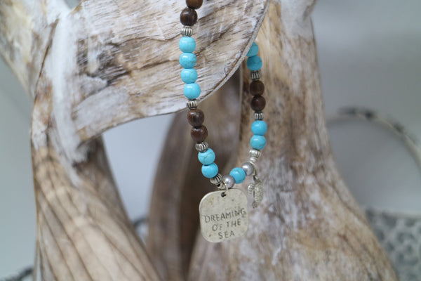 Load image into Gallery viewer, Blue howlite gemstone and wood beaded bracelet with silver rustic &#39;dreaming of the sea&#39; and turtle charms

