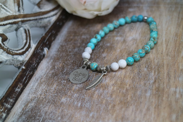 Load image into Gallery viewer, Blue Sea Sediment Jasper with white Howlite bead bracelet with silver &#39;gypsy soul&#39; and feather charms
