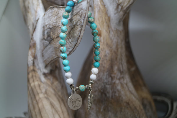 Load image into Gallery viewer, Blue Sea Sediment Jasper with white Howlite bead bracelet with silver &#39;gypsy soul&#39; and feather charms
