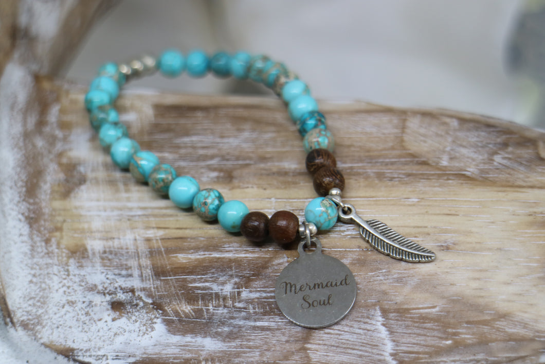 Blue Sea Sediment Jasper and wood beaded bracelet with silver 'mermaid soul' and boho feather charm