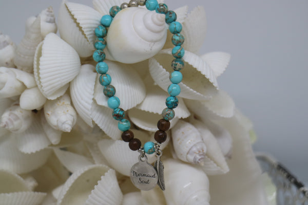 Load image into Gallery viewer, Blue Sea Sediment Jasper and wood beaded bracelet with silver &#39;mermaid soul&#39; and boho feather charm
