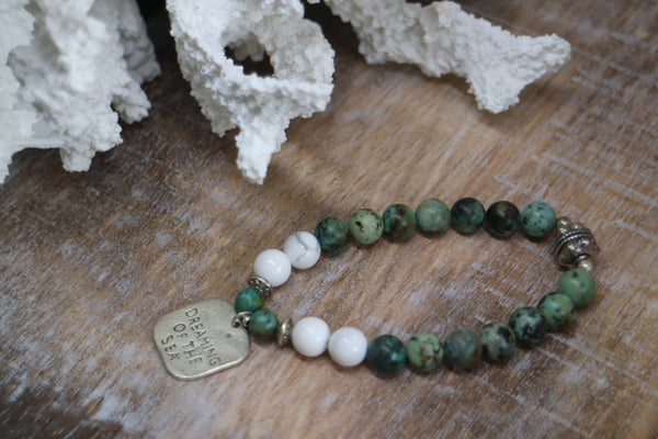 Load image into Gallery viewer, African Turquoise and white howlite beaded bracelet with silver rustic &#39;dreaming of the sea&#39; charm
