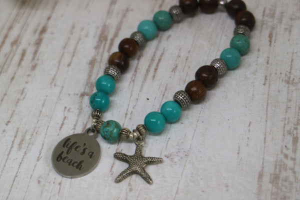 Load image into Gallery viewer, Turquoise gemstone and wood beaded bracelet with silver &#39;life&#39;s a beach&#39; and starfish charms
