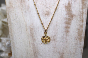 Gold sand dollar shell necklace