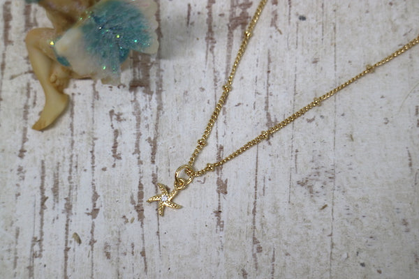 Load image into Gallery viewer, Children&#39;s gold starfish necklace with cubic zirconia

