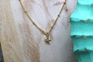 Children's gold starfish necklace with cubic zirconia