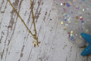 Children's gold starfish necklace with cubic zirconia