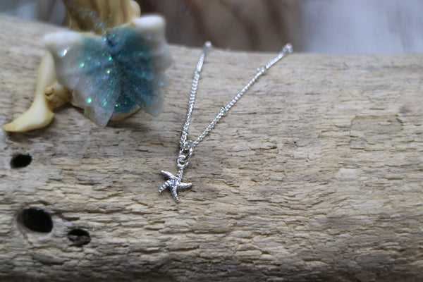 Load image into Gallery viewer, Children&#39;s silver starfish necklace with cubic zirconia
