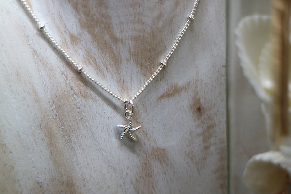 Load image into Gallery viewer, Children&#39;s silver starfish necklace with cubic zirconia
