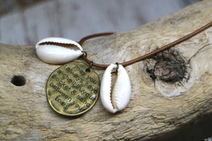 Cowrie shell and engraved antique bronze pendant on a brown leather cord necklace